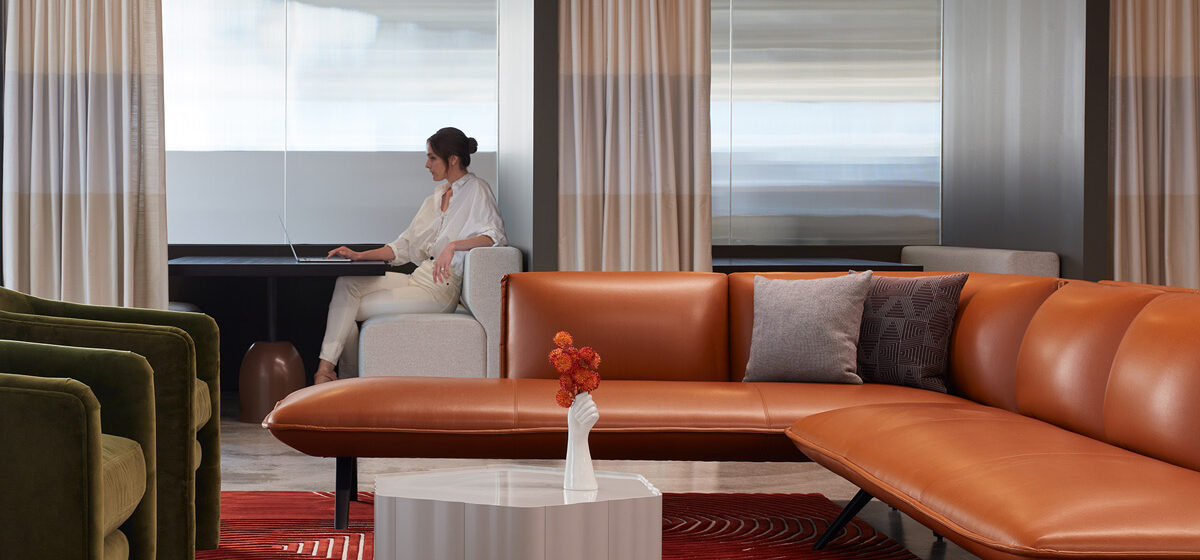 Woman sitting in front of Houdini privacy glass wall