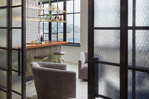 Chicken wire glass doors enclosing a bar.