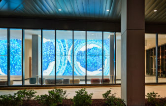 Bendheim TurnKey Fusion glass cladding system in a lobby, seen from outside.