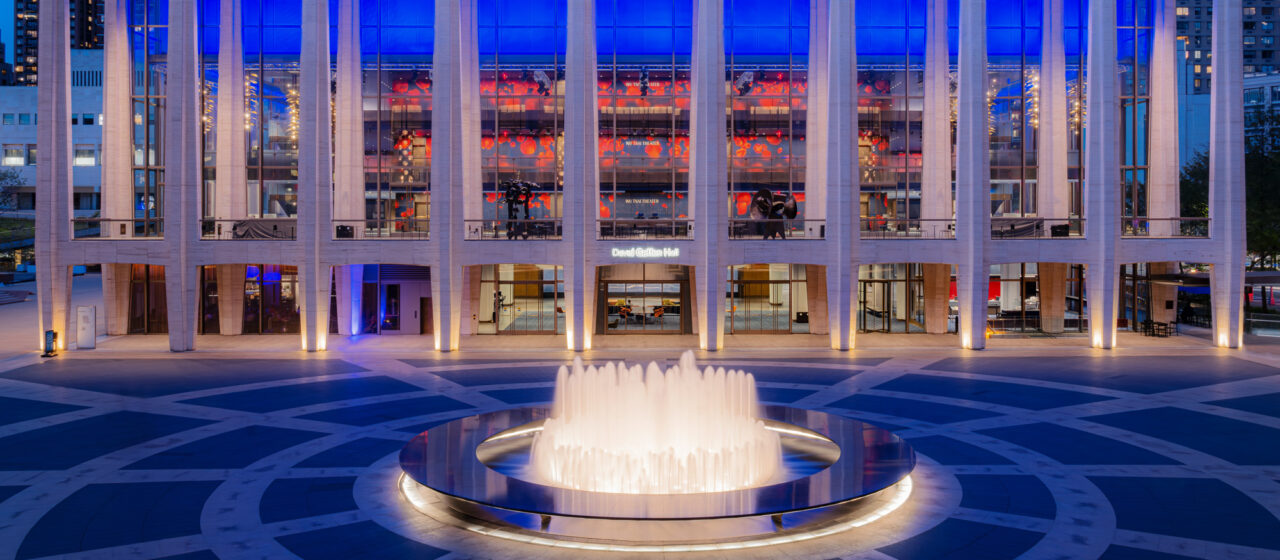 David Geffen Hall at night with Bendheim's illuminated glass wall.