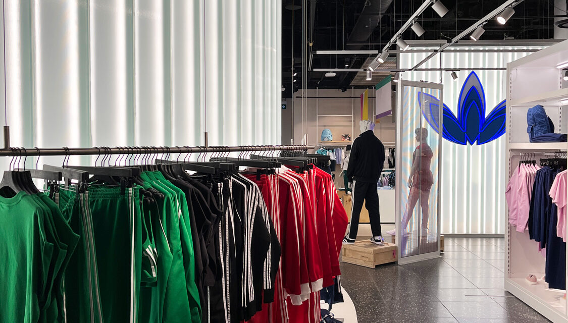 Channel glass partition wall in Adidas store.