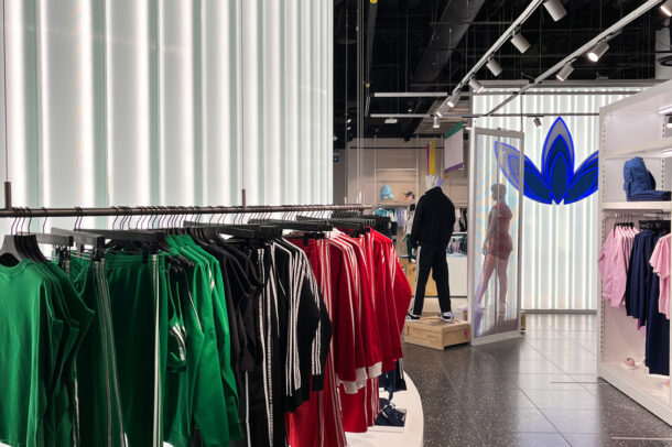 Channel glass partition wall in Adidas store.