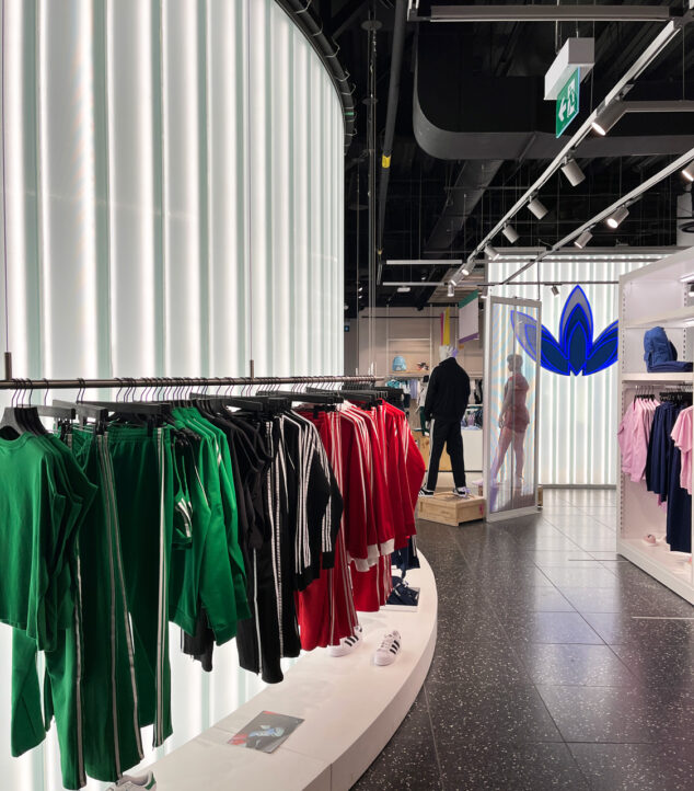 Channel glass partition wall in Adidas store.