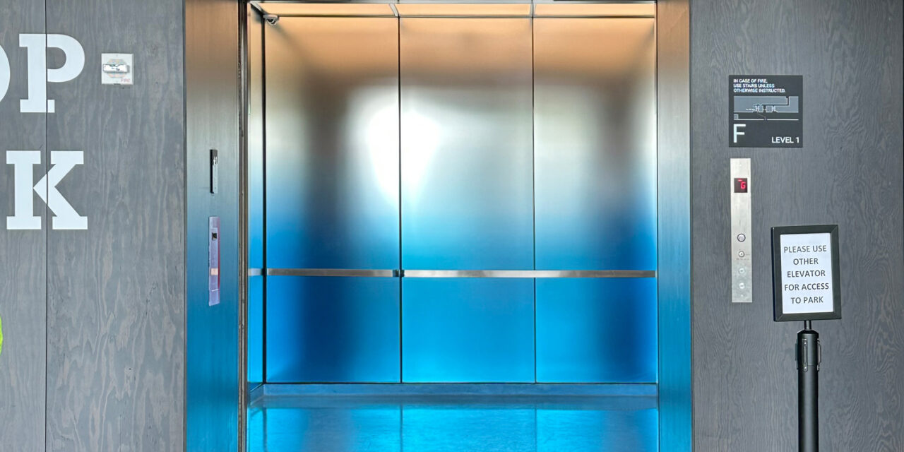 Elevator interior with glass walls.