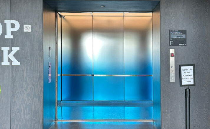 Elevator interior with glass walls.