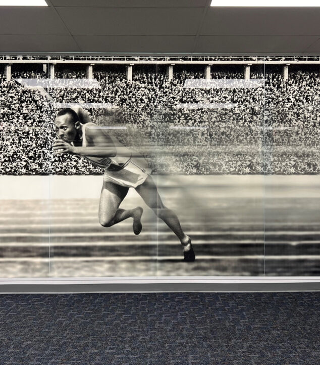 Lobby with Bendheim's TurnKey Fusion Light Wall, featuring a glass mural of Jesse Owens