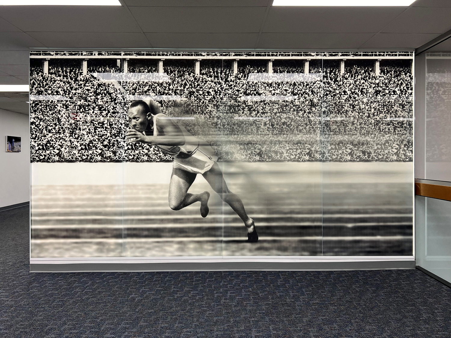 Lobby with Bendheim's TurnKey Fusion Light Wall, featuring a glass mural of Jesse Owens