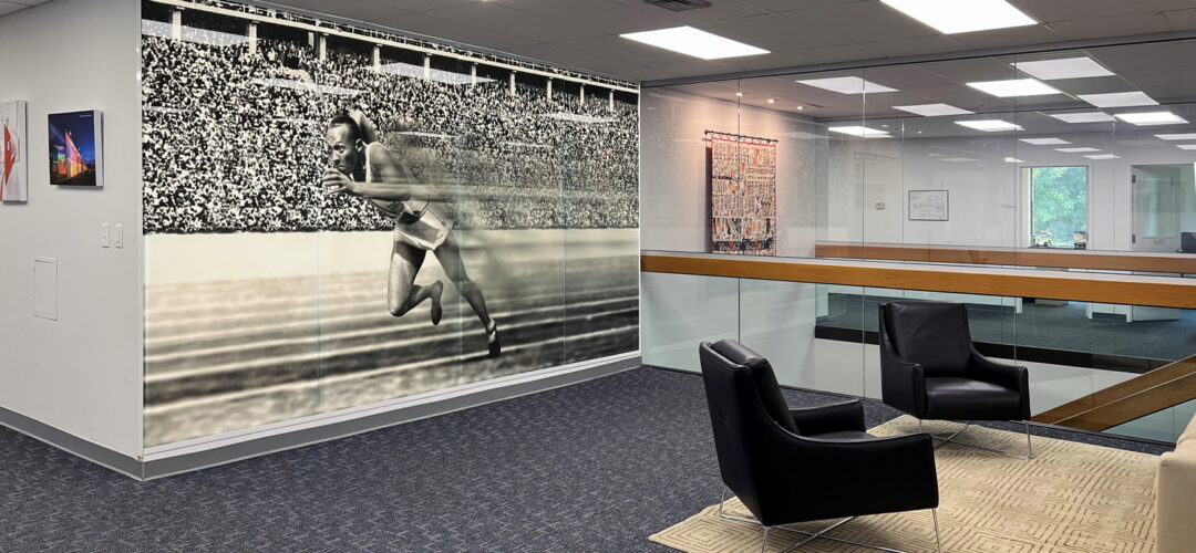 Lobby with Bendheim's TurnKey Fusion Light Wall, featuring a glass mural of Jesse Owens