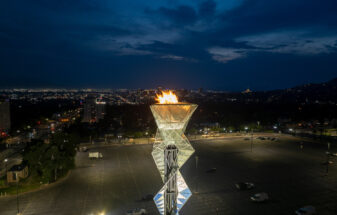 Olympic Cauldron torch lit at night.