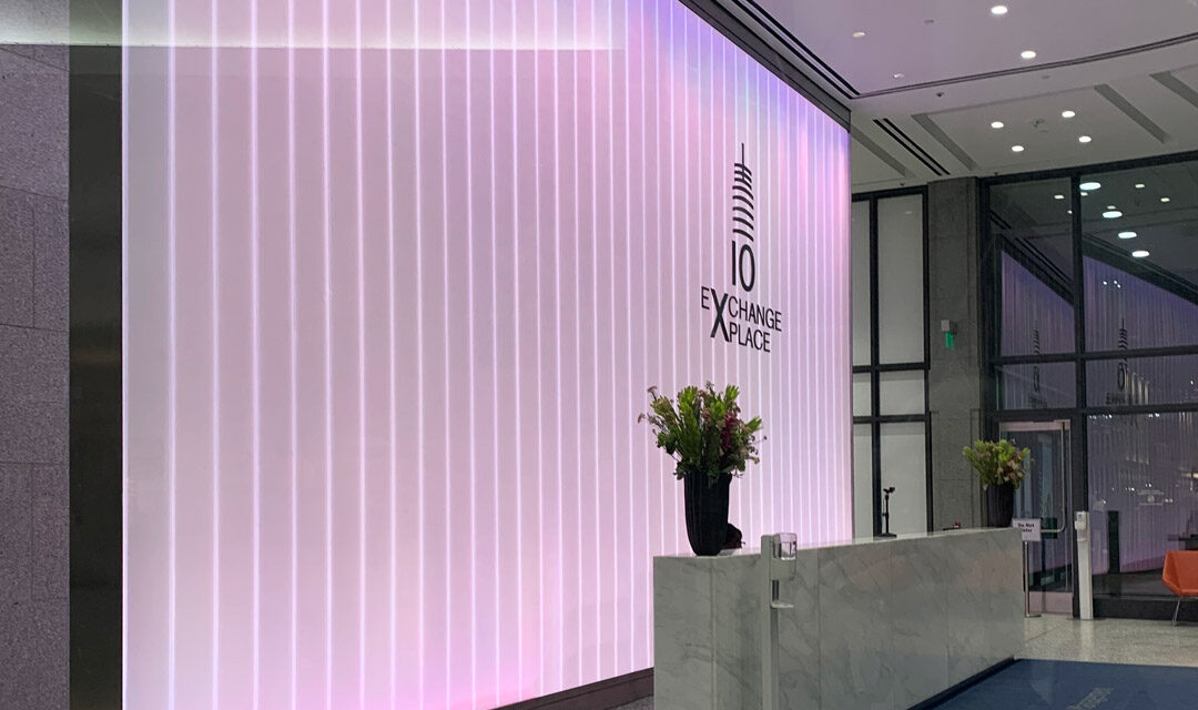 Back-lit channel glass wall in a lobby.