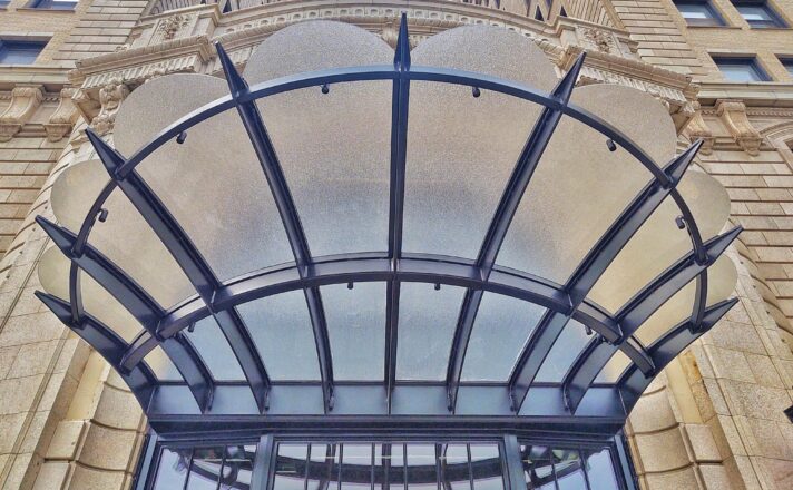 Textured glass creates a canopy above the building entrance.