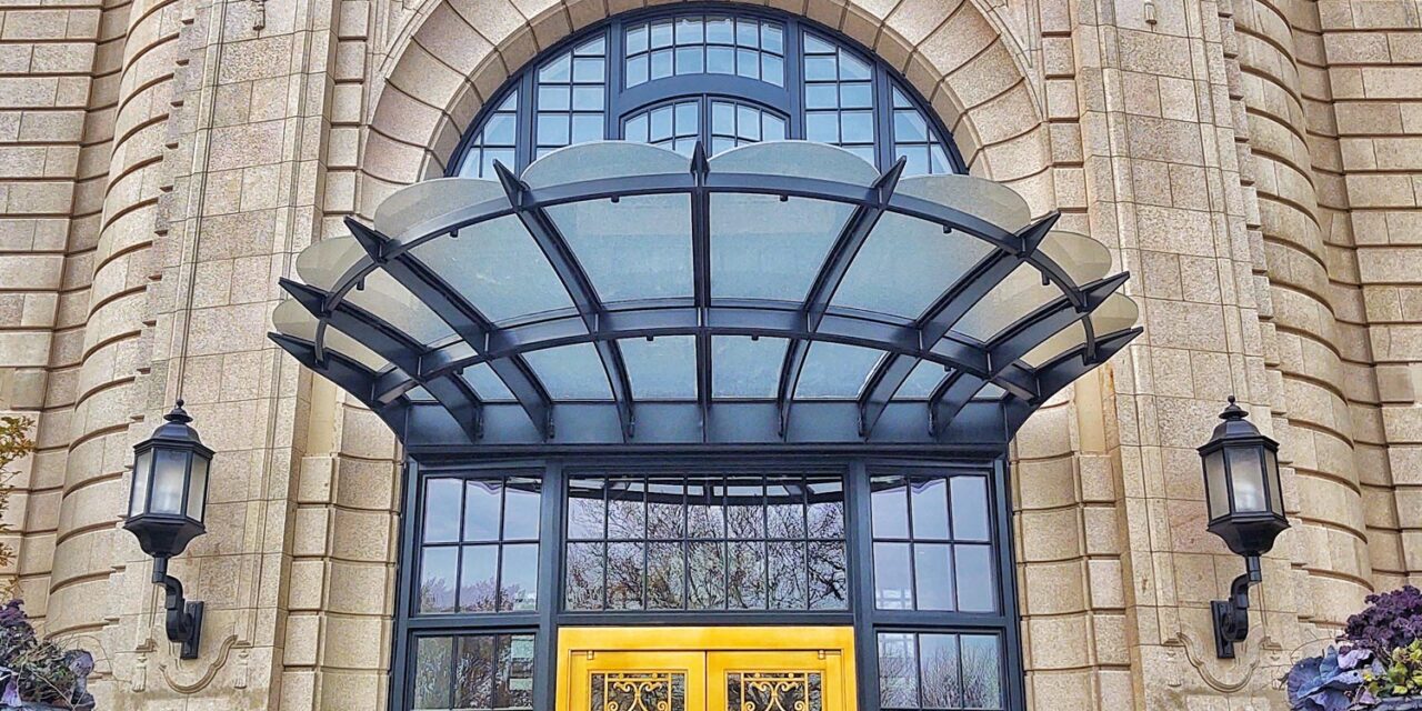 Textured glass creates a canopy above the building entrance.