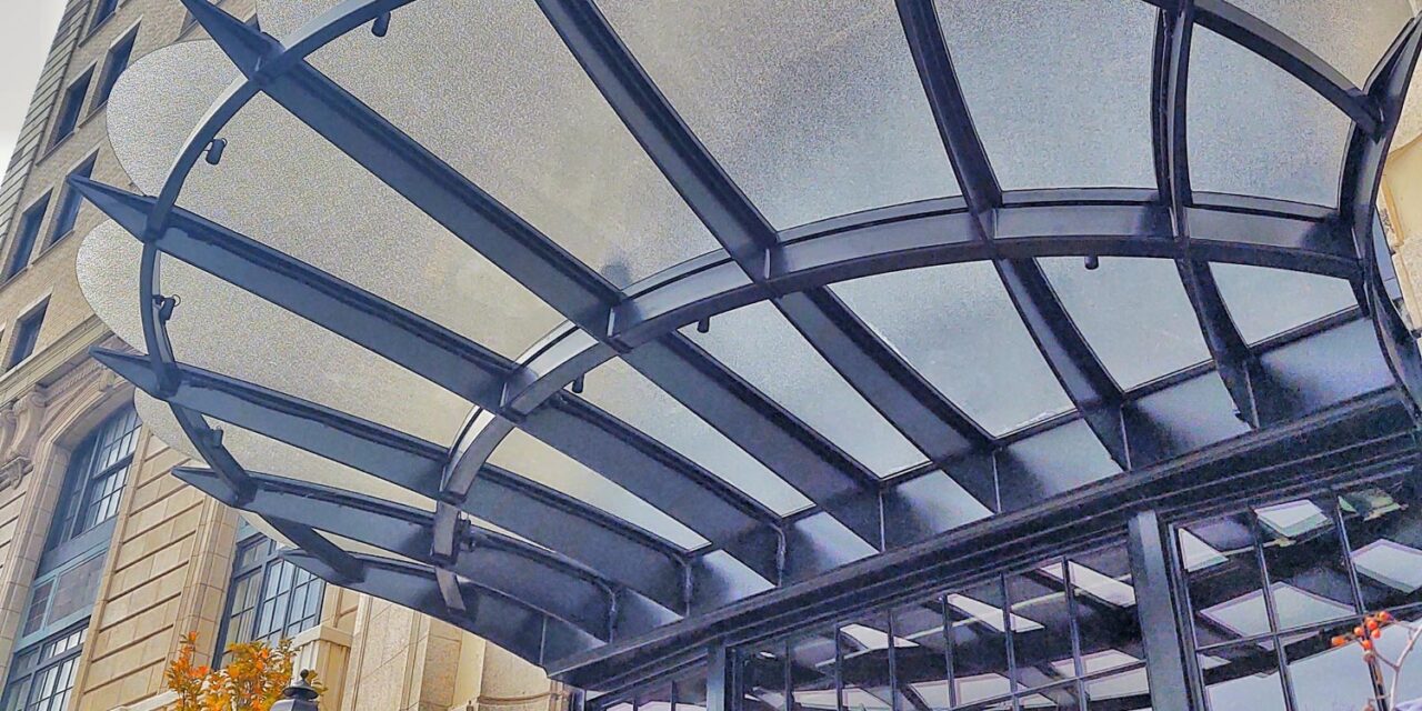 Textured glass creates a canopy above the building entrance.