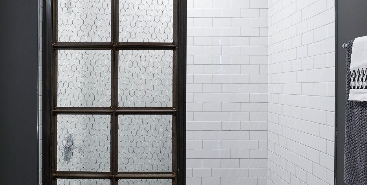 Shower enclosure with door made of Bendhiem's chicken wire glass.