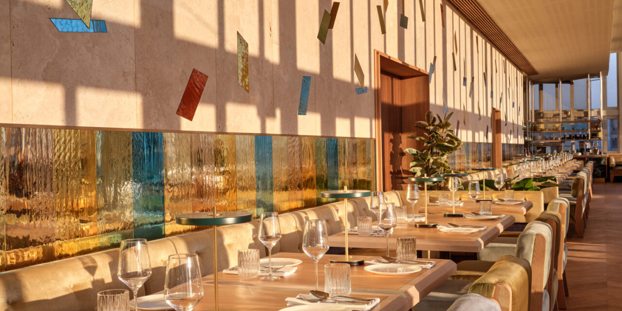Restaurant with colorful mirrored mouth-blown glass panels in the walls.