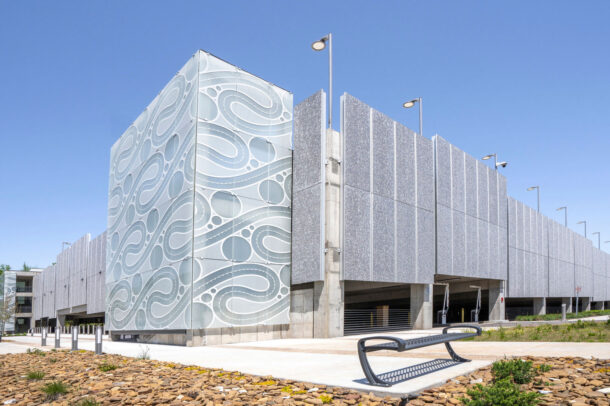 Etched, fritted glass enclosing the staircase of the parking structure.