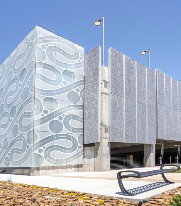 Etched, fritted glass enclosing the staircase of the parking structure.