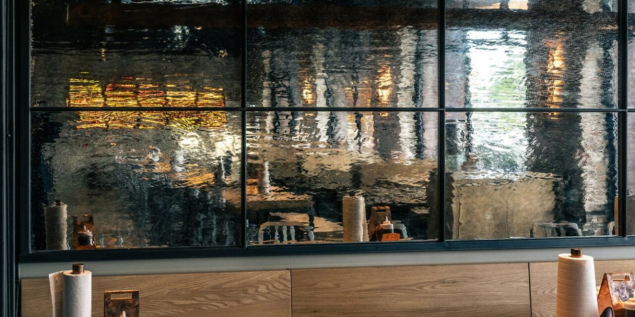 Textured mirrored glass wall in a restaurant.