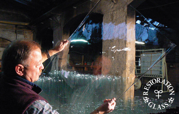 Man holding sheet of Restoration Glass