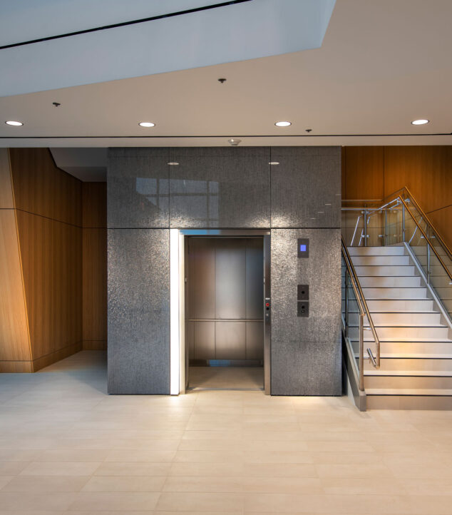 Bendheim's TurnKey glass wall cladding system on the exterior of an elevator enclosure.