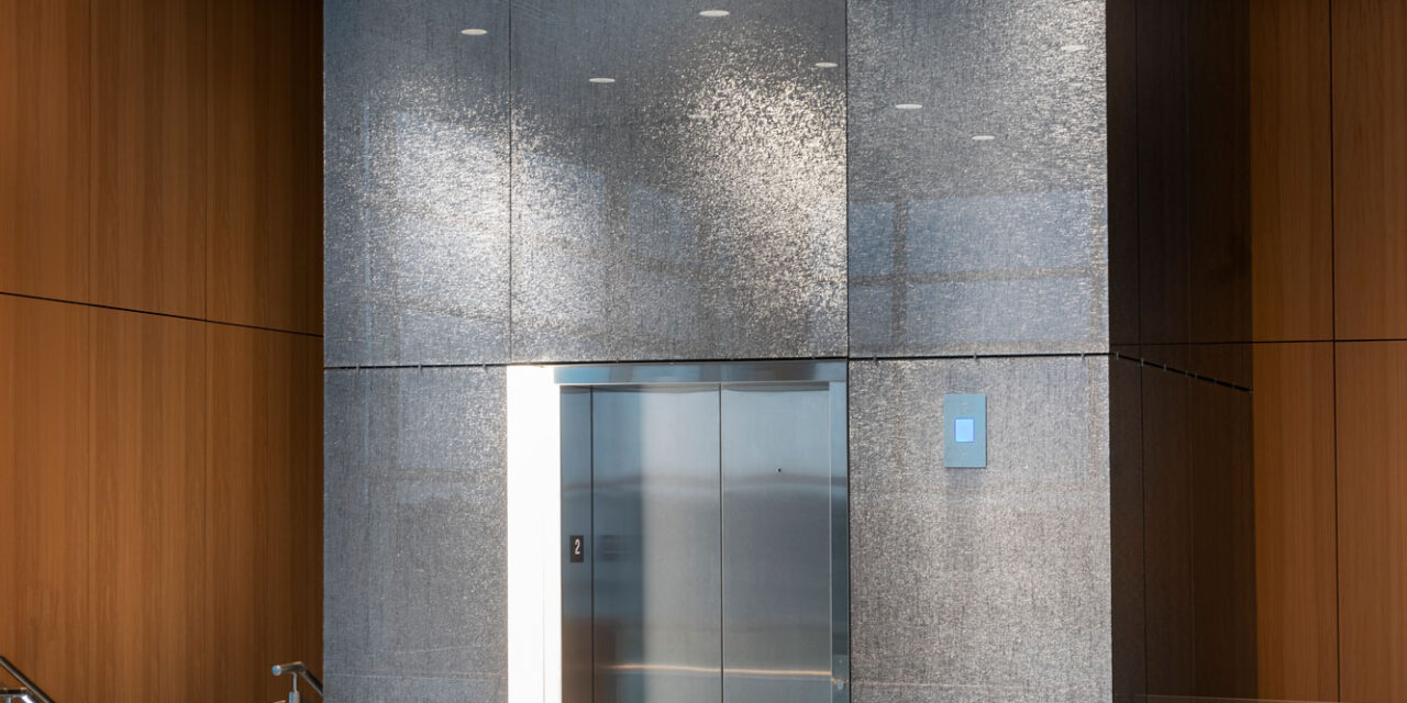 Bendheim's TurnKey glass wall cladding system on the exterior of an elevator enclosure.