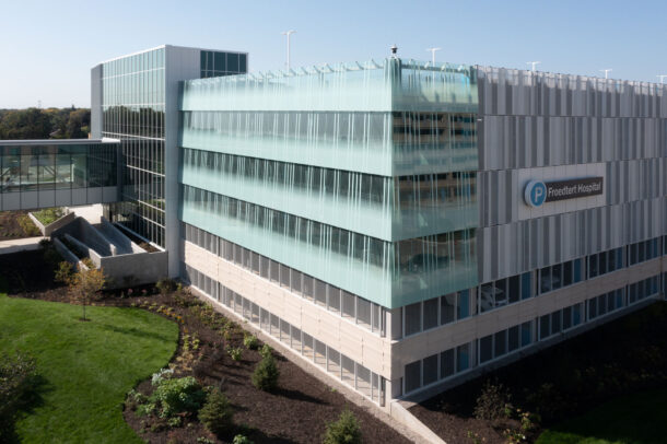Bendheim glass rainscreen system on the exterior of a parking structure.