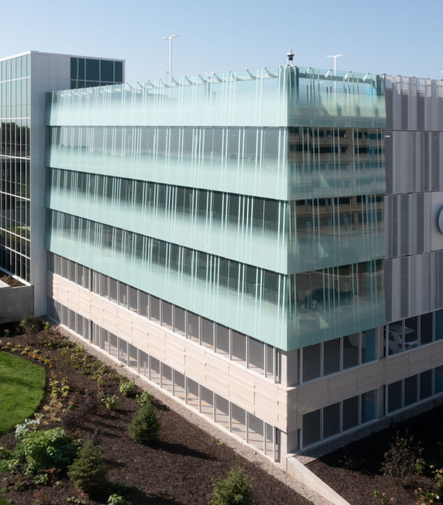 Bendheim glass rainscreen system on the exterior of a parking structure.