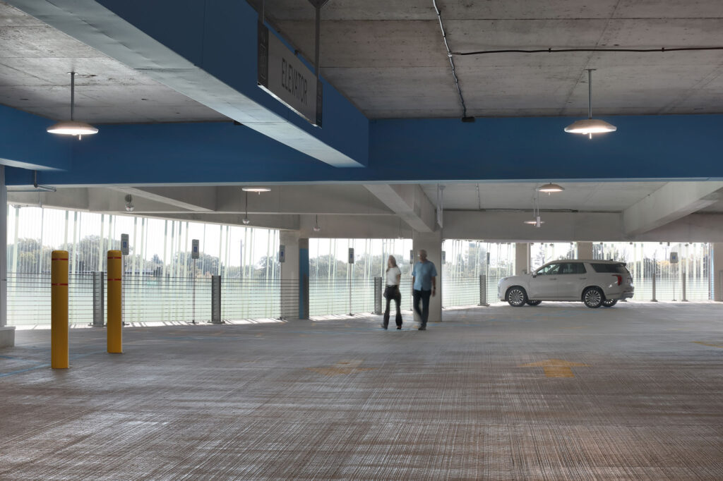 Bendheim glass rainscreen system on the exterior of a parking structure, seen from inside.