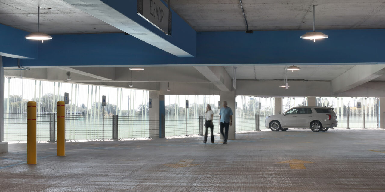 Bendheim glass rainscreen system on the exterior of a parking structure, seen from inside.