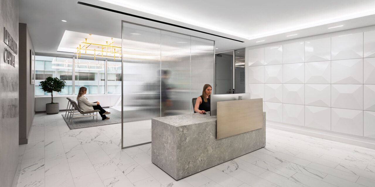 Fluted glass partition wall by Bendheim in an office.