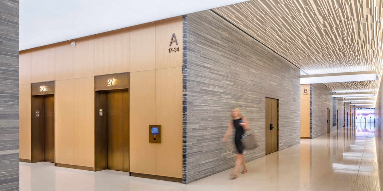 Bendheim laminated glass cladding the walls of a lobby elevator.