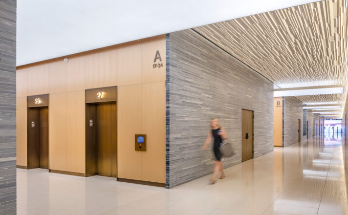 Bendheim laminated glass cladding the walls of a lobby elevator.