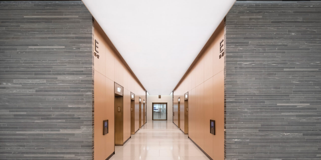 Bendheim laminated glass cladding the walls of a lobby elevator.