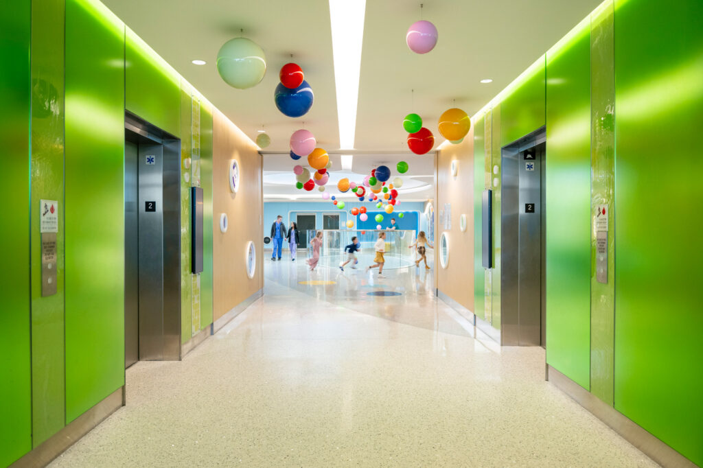 Elevator lobby walls made of colorful Bendheim glass.