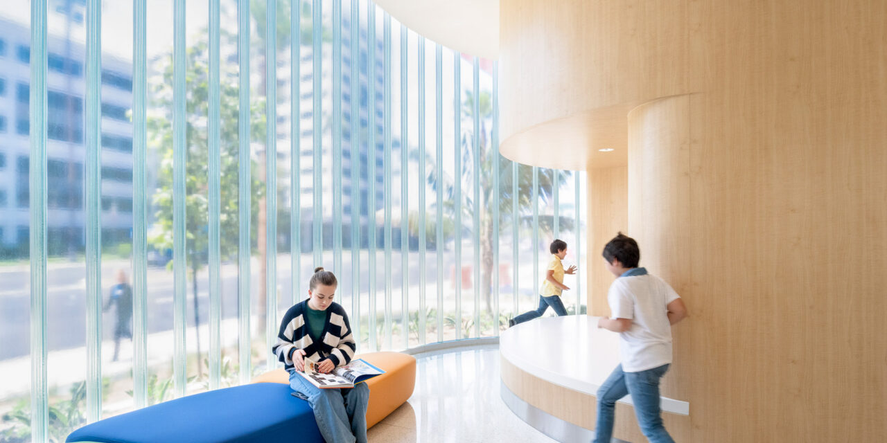 Exterior wall of channel glass by Bendheim with children playing nearby.