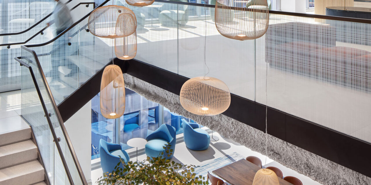 Glass stair railing by Bendheim with a woven digital printed pattern.