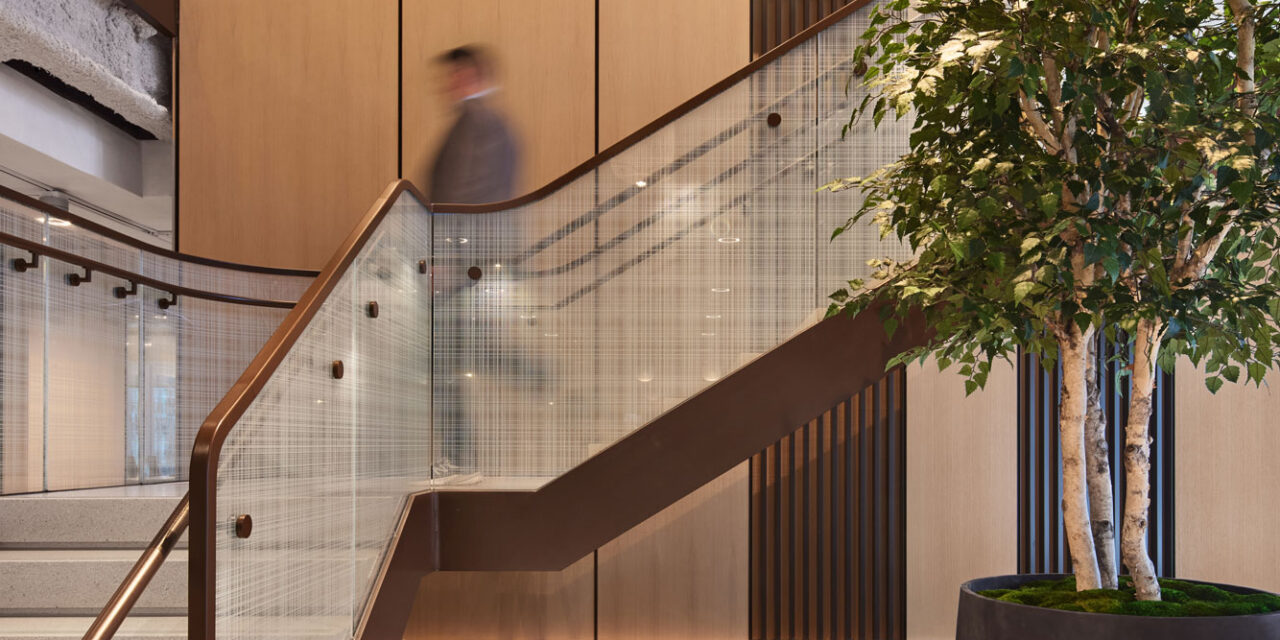 Glass stair railing by Bendheim with a woven digital printed pattern.