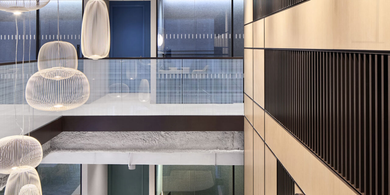 Glass stair railing by Bendheim with a woven digital printed pattern.