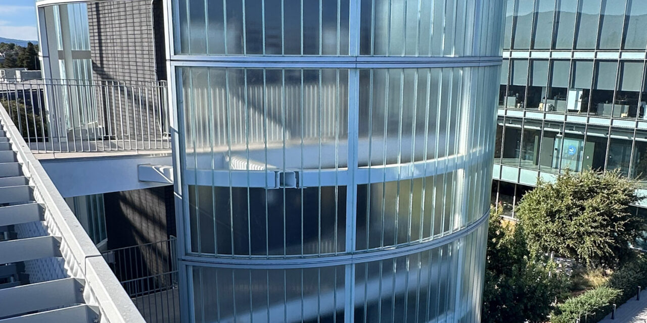 Curved channel glass wall by Bendheim over the exterior elevator lobby.