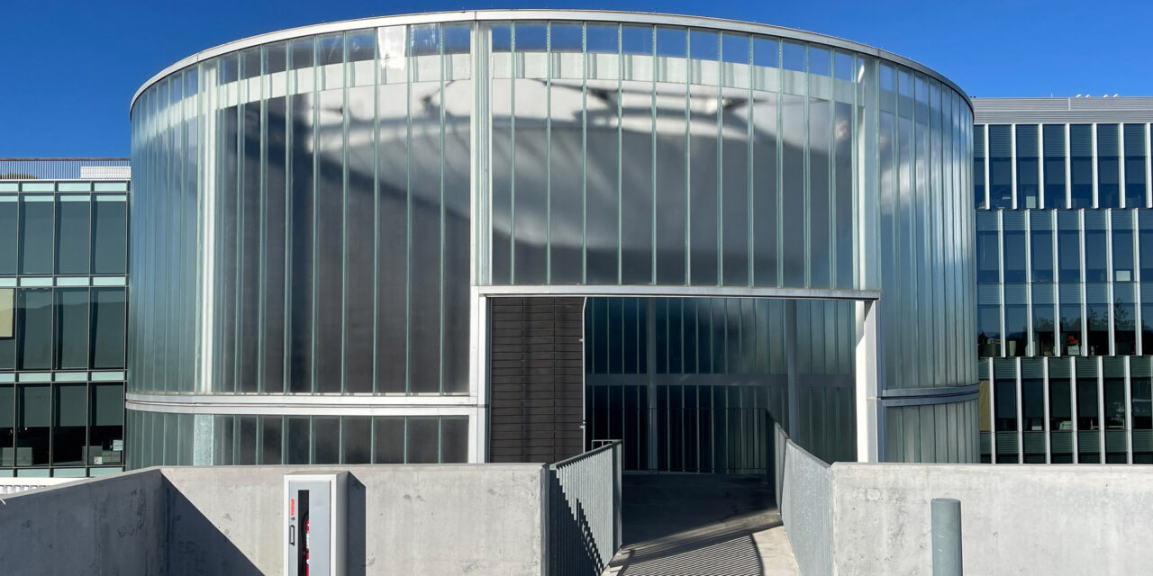 Curved channel glass wall by Bendheim over the exterior elevator lobby.