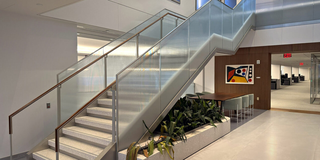 Textured glass railing of a stairwell in an office.