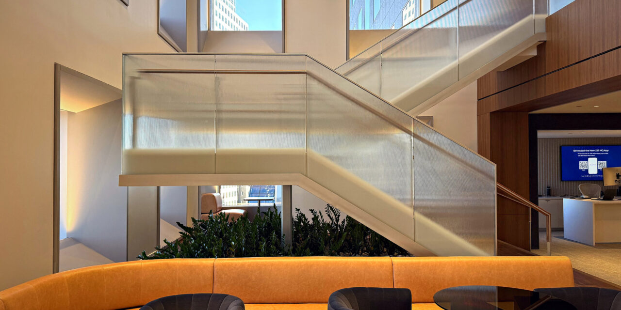 Textured glass railing of a stairwell in an office.