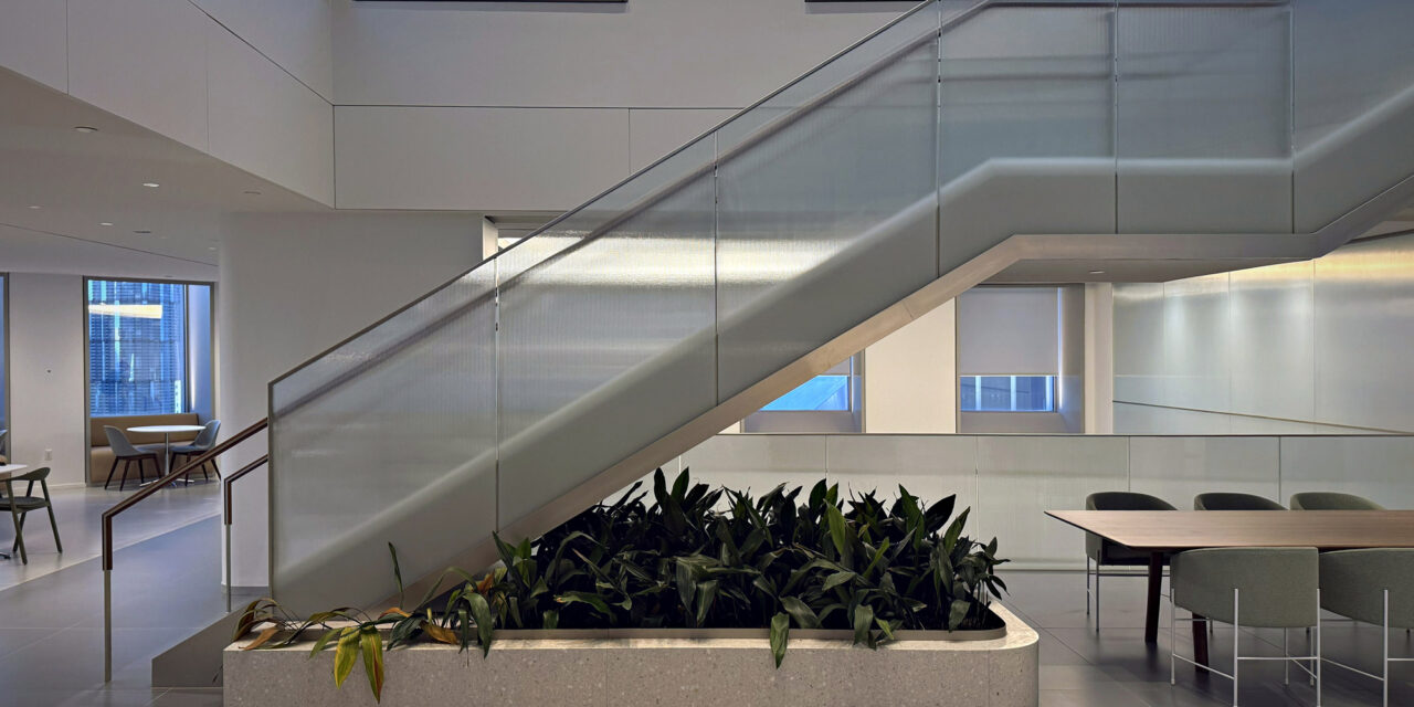 Textured glass railing of a stairwell in an office.