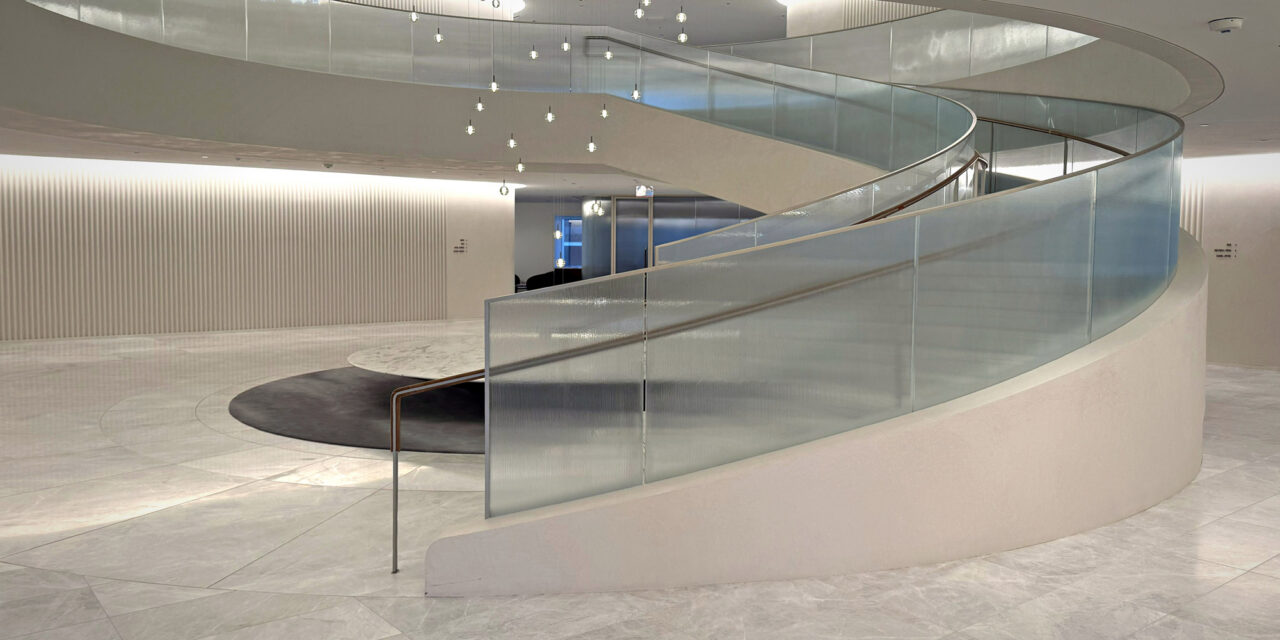 Textured glass railing of a stairwell in an office.