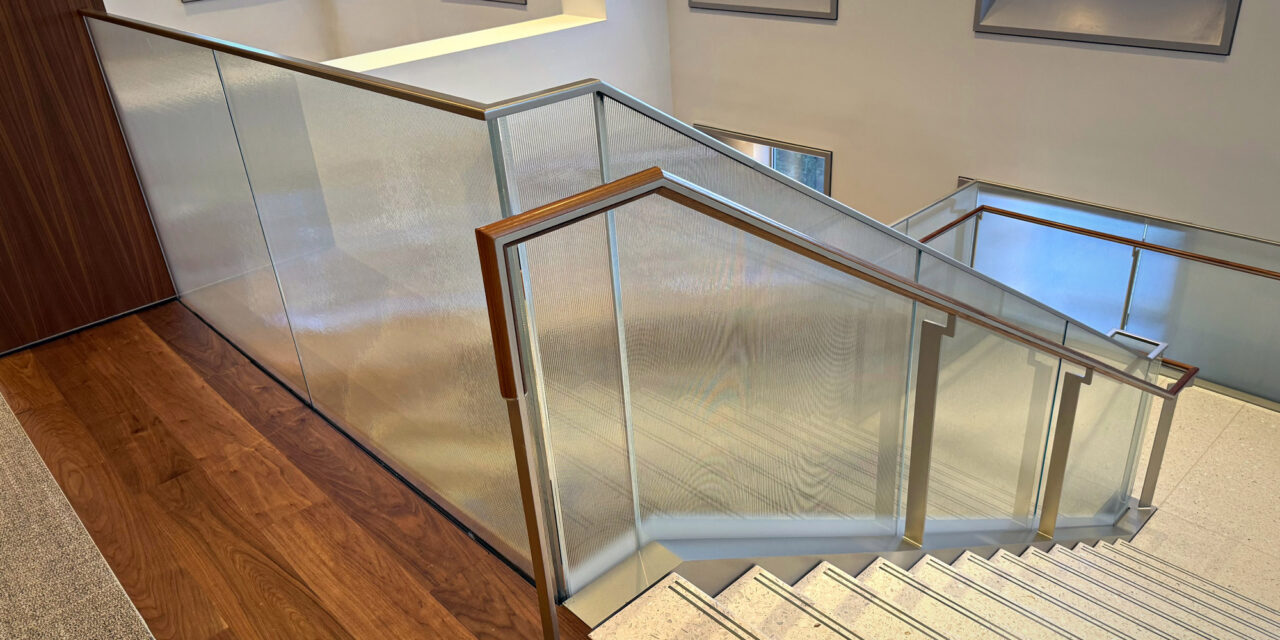 Textured glass railing of a stairwell in an office.