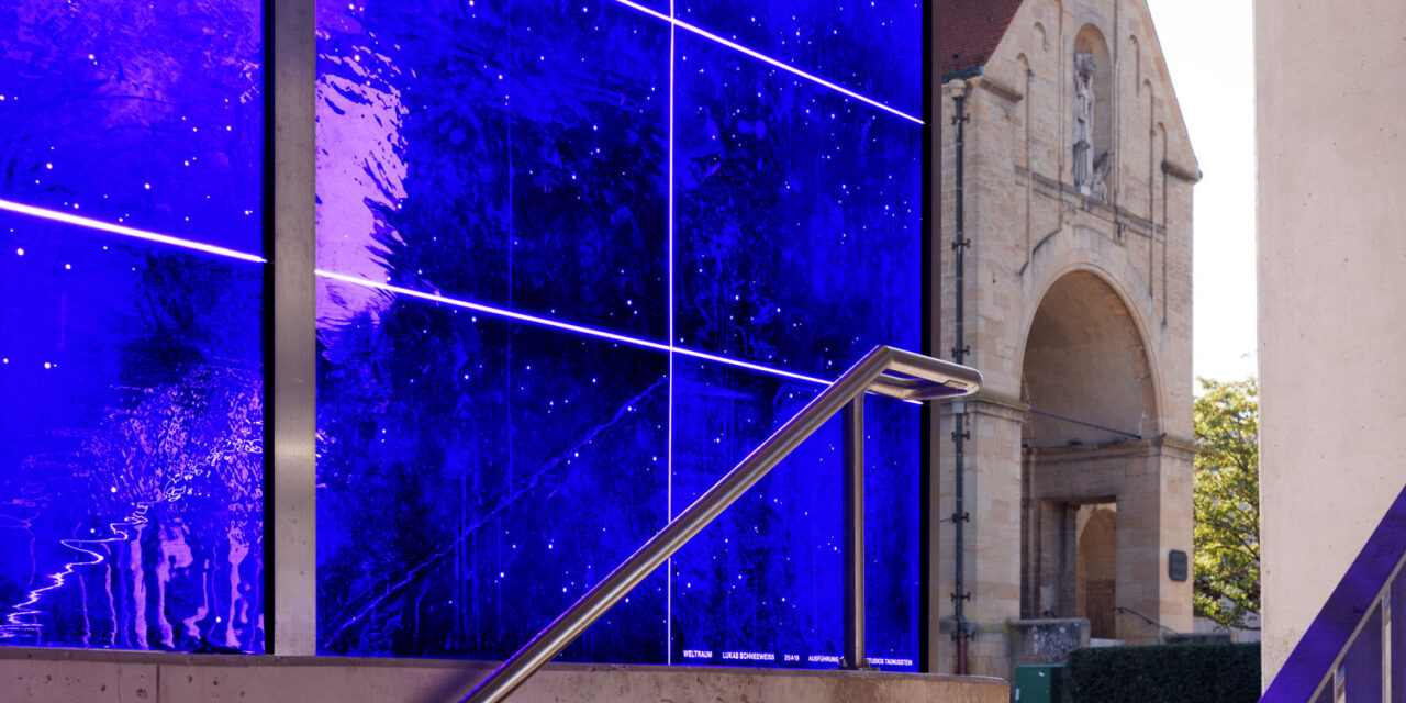 Blue mouth-blown glass enclosing a stairwell.
